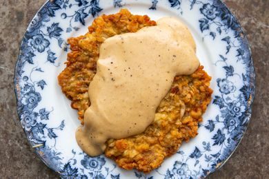Easy chicken fried steak covered with gravy on a plate