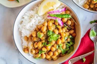 Best Chana Masala bowl of chana masala with rice, and lemon wedge