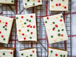 Gingerbread Bars frosted and decorated with festive sprinkles and set on a rack.