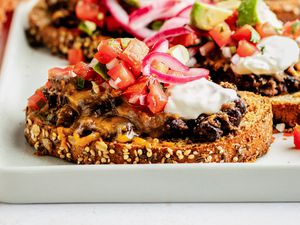 Black bean toast on a platter with lots more