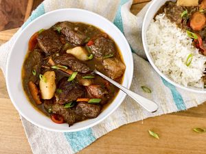 Jamaican Stewed Beef in two bowls and served with rice.
