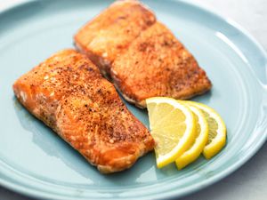 Air Fryer Salmon on a Plate with Lemon Wedges