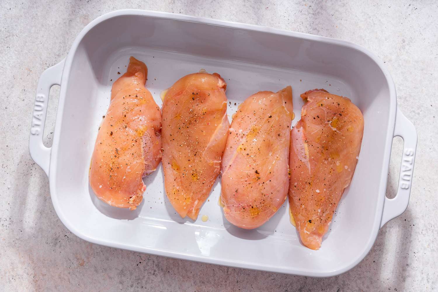 Seasoned chicken breast in a casserole dish for easy chicken breast recipe