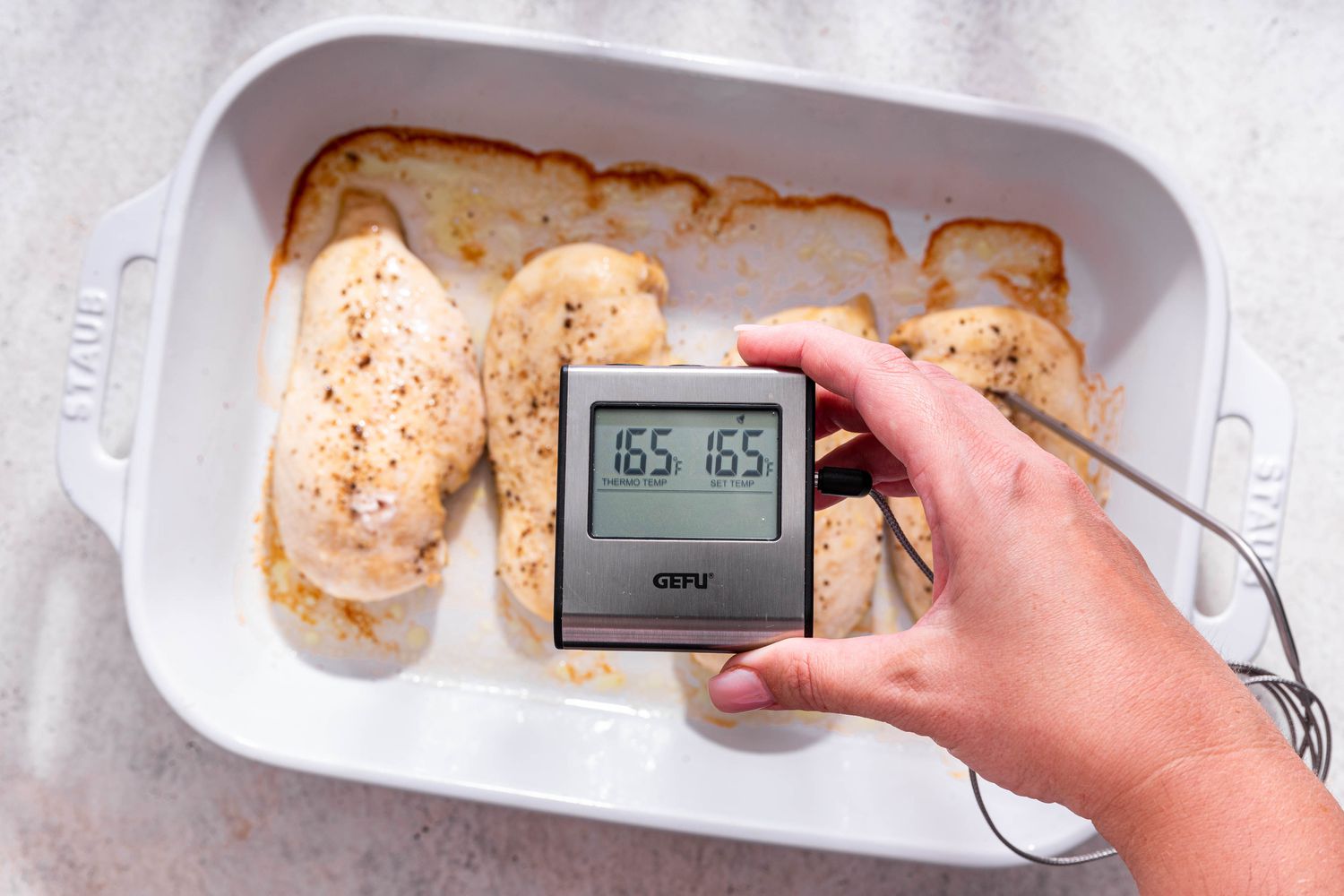 Electric thermometer reading 165F after baked chicken is rested