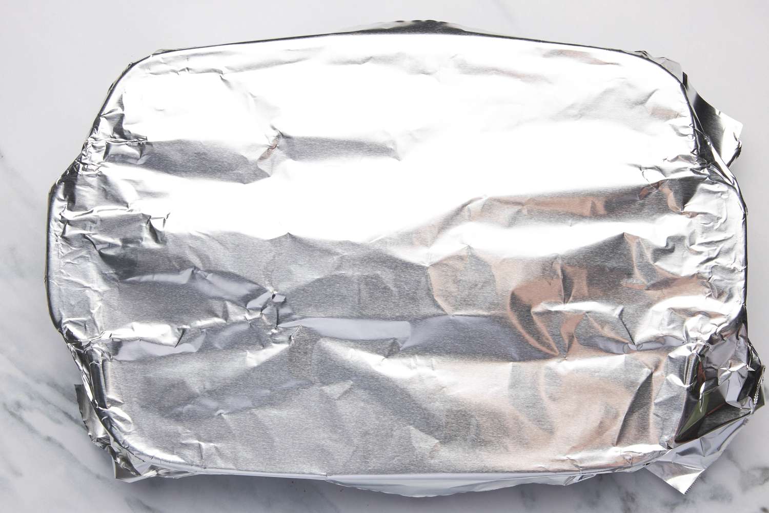 Casserole dish covered with aluminium foil for one pan penne alla vodka recipe