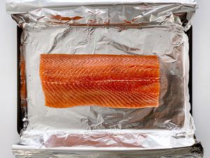 Unbaked salmon on a foil lined baking sheet to make Garlic Butter Baked Salmon.