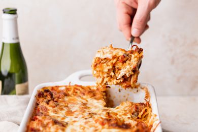 baked spaghetti casserole being served from a dish