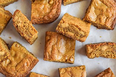 Overhead view of blonde brownies scattered on a counter