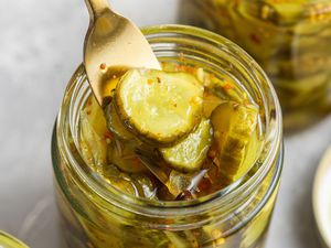 Bread and Butter Pickles Picked up from a Jar Using a Fork