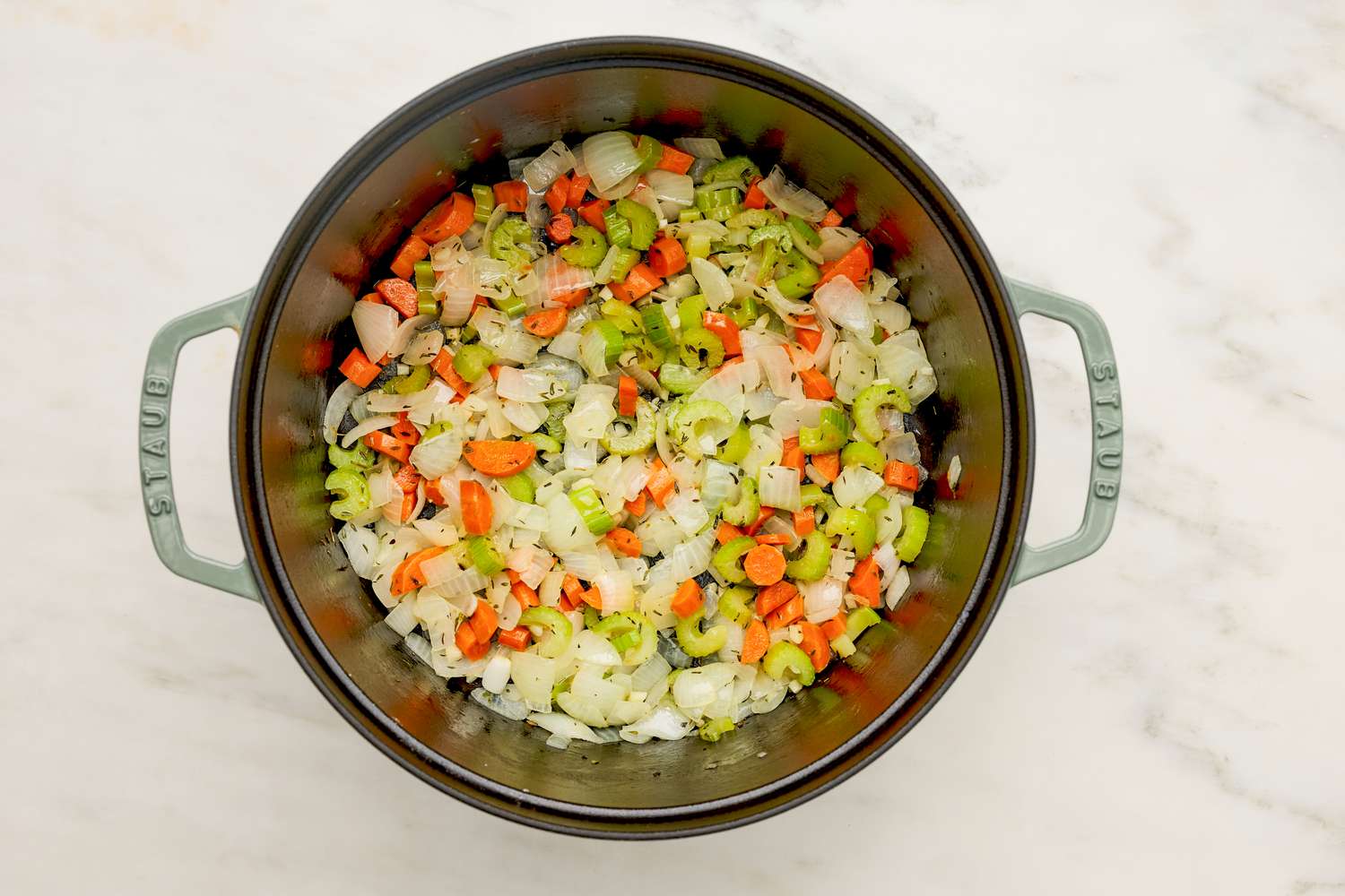 Stock vegetables sauteed in a Dutch oven for chicken pot pie soup recipe