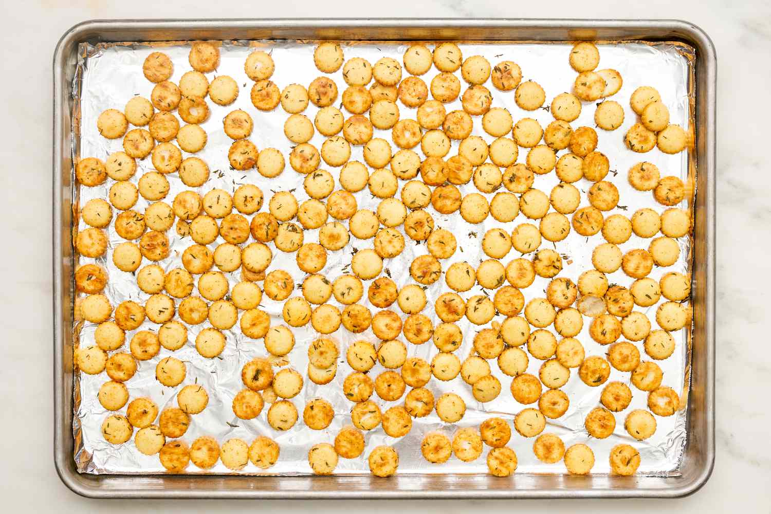 Toasted oyster crackers on an aluminum foil lined baking sheet for chicken pot pie soup recipe