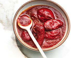 A ceramic bowl of chipotle peppers in adobo sauce