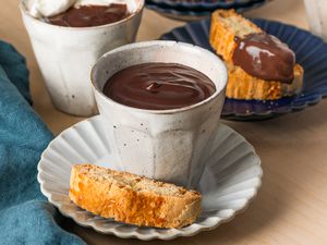 Two mugs of Cioccolato Caldo con Latte (Italian Hot Chocolate) in small white mugs with biscotti