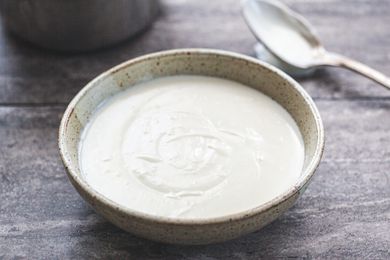 Side view of basic béchamel sauce in a bowl.