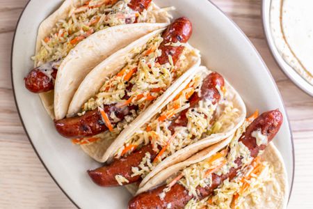 Overhead: Plate of Ronto Wraps Topped With Slaw and Dressing and a Plate With More Flatbread