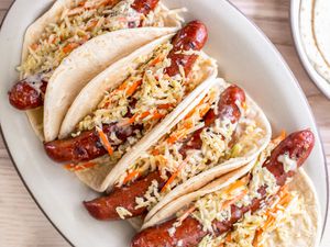 Overhead: Plate of Ronto Wraps Topped With Slaw and Dressing and a Plate With More Flatbread