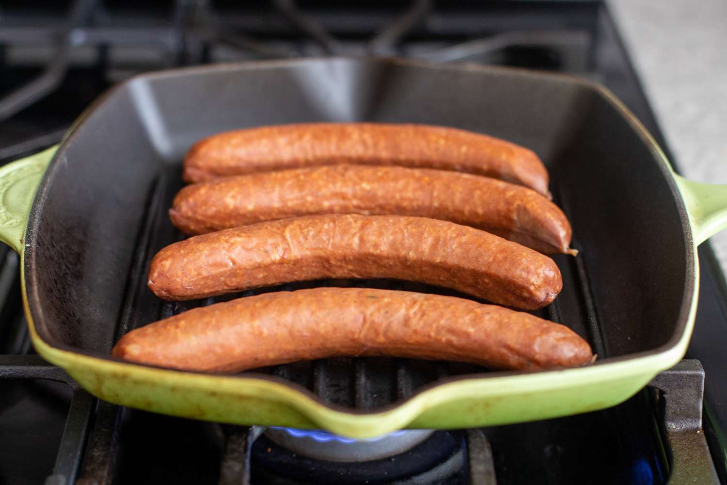 Pork Sausage Links Added to Heated Grill Pan on the Stove