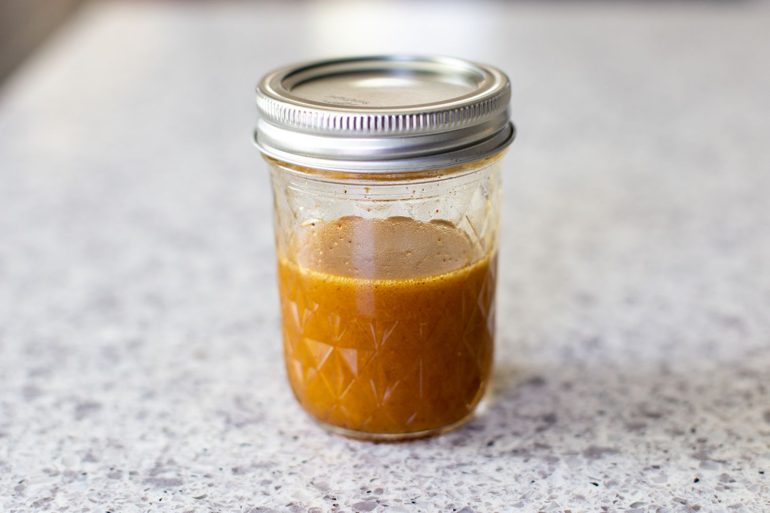 Mason Jar of Coleslaw Dressing Ingredients After Shaken Together 