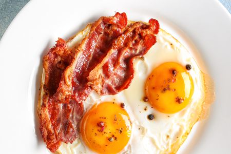 Plate with fried eggs and bacon