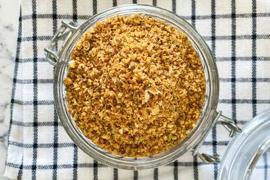 Overhead view of Dukkah spice blend in a glass container.