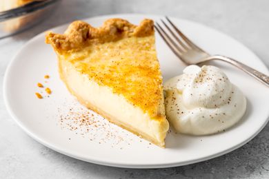 Slice of Egg Custard Pie on Plate with Cream