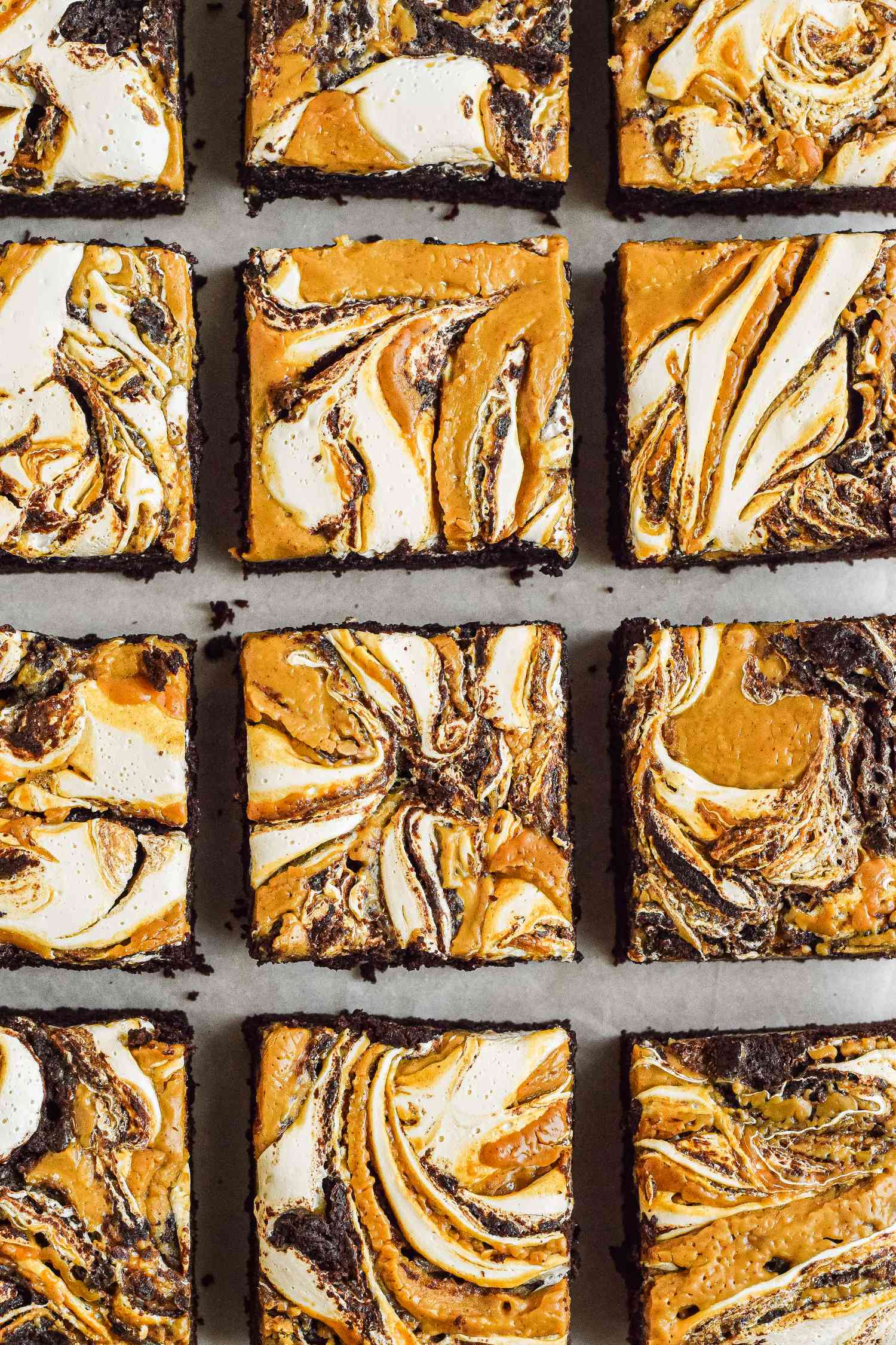 Close-up: fluffernutter brownie cut into squares on a piece of parchment paper