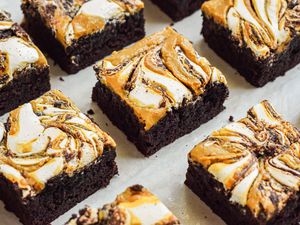 Fluffernutter brownie cut into squares on a piece of parchment paper