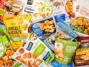 Different brands of chicken nuggets (still in the bag) splayed on a counter