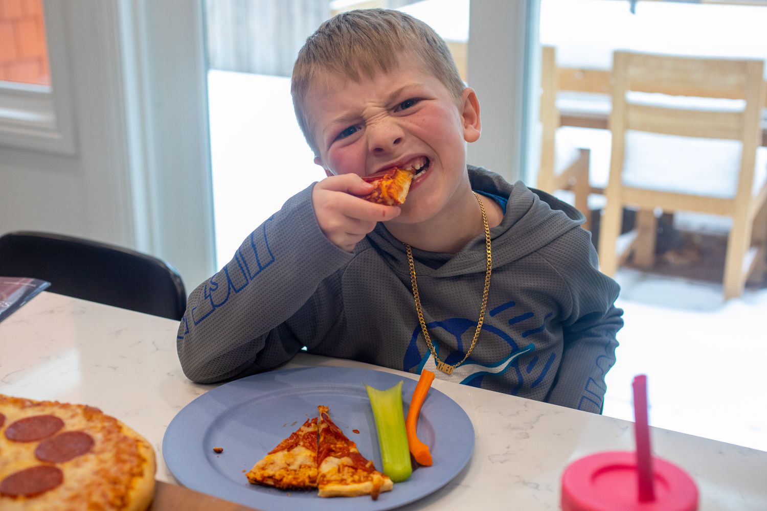 Kid eating frozen pizza