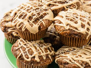 Gingerbread latte muffins topped with coffee glaze and coffe sugar mixture stacked on a plate