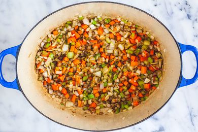 Chopped carrots, celery, and onion in a dutch oven for an oxtail recipe.