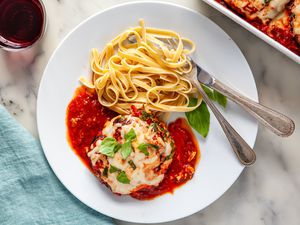 Quick and easy gluten free eggplant parmesan on a plate with pasta.