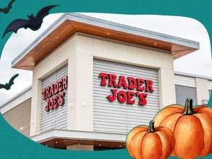 Photo of a Trader Joe's storefront with Halloween illustrations on top of it (illustrations of bats and pumpkins