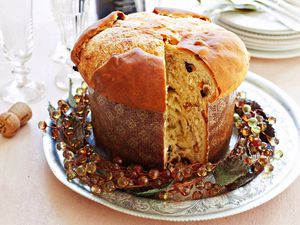 A round loaf of panettone with a slice removed