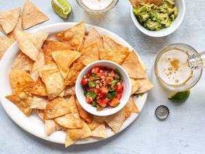 A plate of tortilla chips and beer