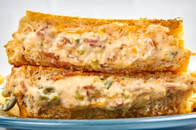 Cross-section of jalapeÃ±o popper grilled cheese (two sandwich halves) stacked on a plate