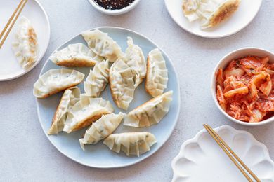 Overhead view of Korean pork and chives dumplings on a plate.