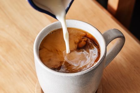 Creamers poured into a cup of coffee