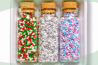 Photo of small jars with sprinkles and on the edges of the photo, a blue and yellow polka dotted border