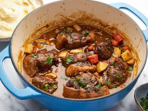A Dutch oven full of oxtail stew on a counter