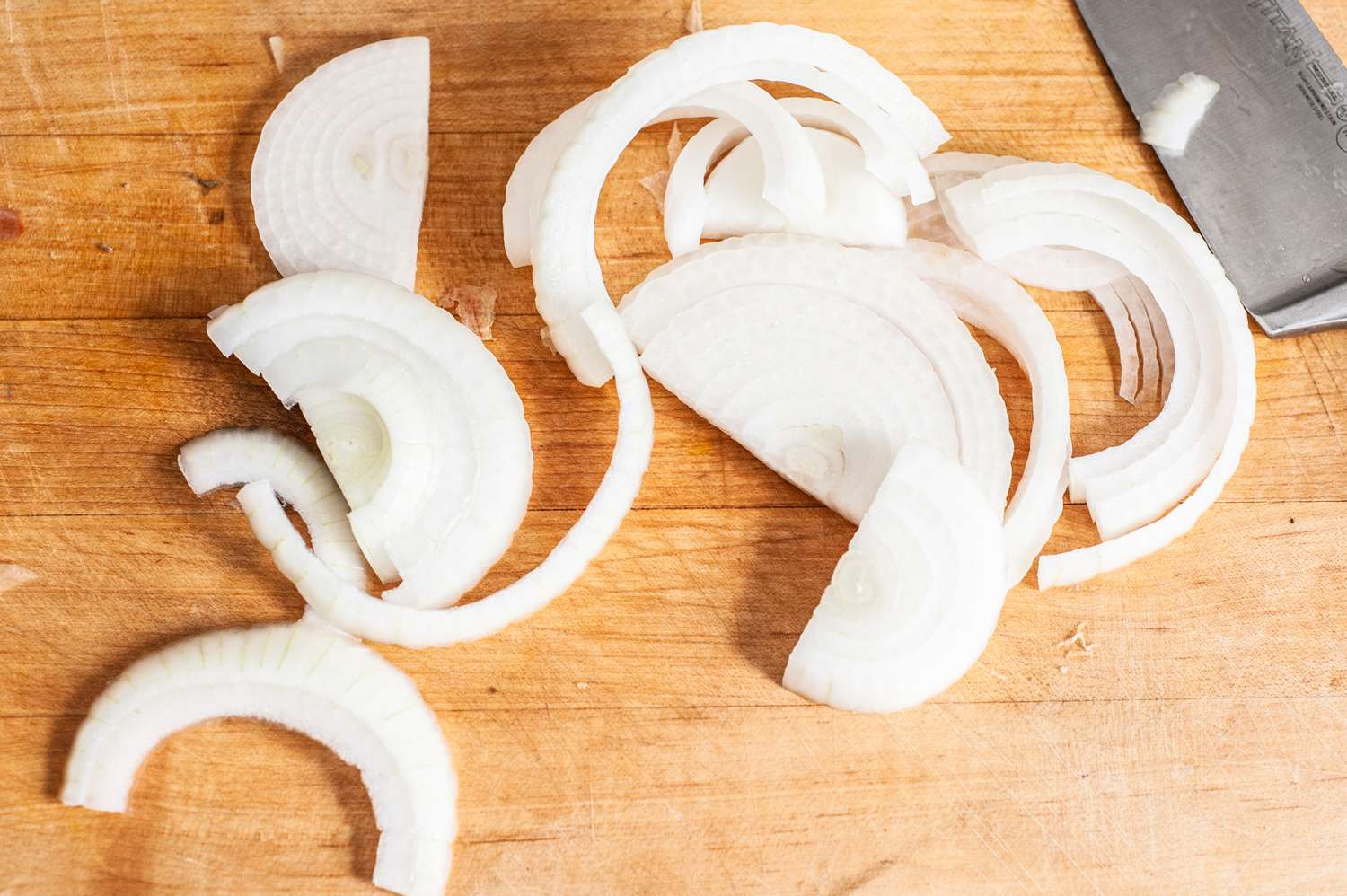 Onions Sliced on a Cutting Board for Vegan Patty Melt Recipe