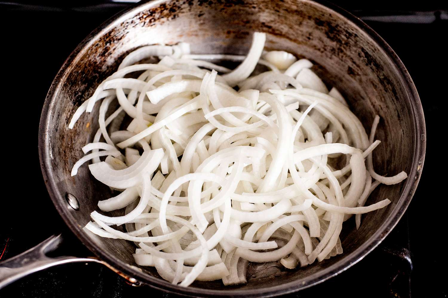 Onions Slices Cooking in a Skillet for Vegan Patty Melt Recipe