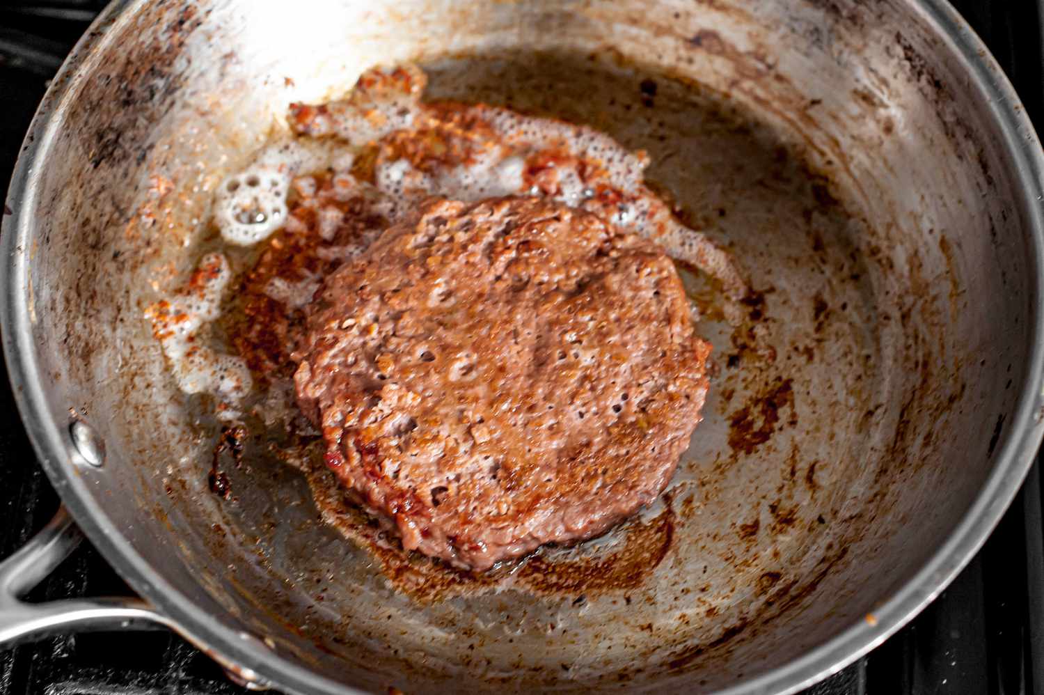 Impossible Burger Patty Cooking in Skillet for Vegan Patty Melt Recipe