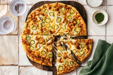 pickle pizza on a cutting board