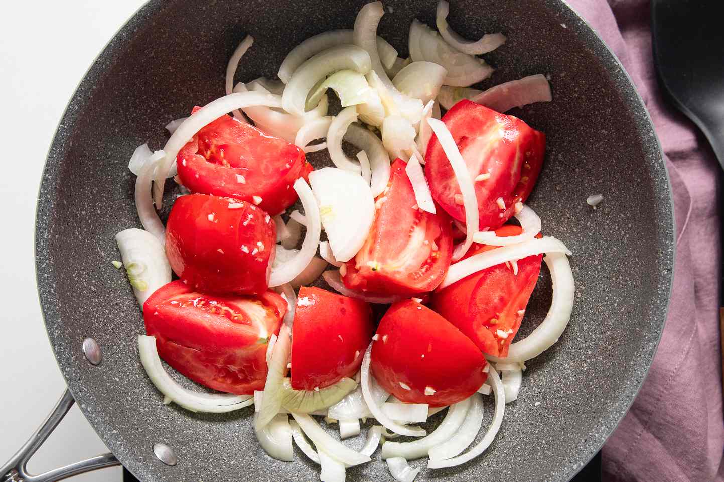 Onions and Tomatoes Cooking in a Pot for Asado de Carajay Recipe