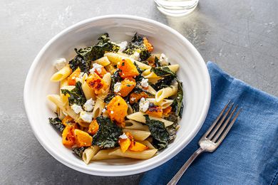 Overhead view of oven roasted kale and squash pasta in a bowl.