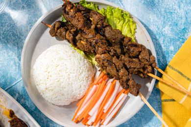 Plate With Sach Ko Jakak (Cambodian Grilled Lemongrass Beef Skewers) With a Mound of Rice and Sliced Daikon Radish and Carrot Pickle