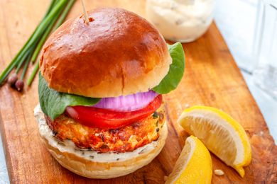 Perfect salmon burger on a wooden board.