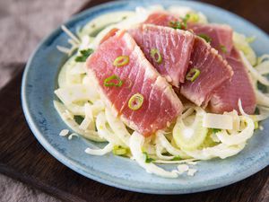 A plate of ahi tuna served over fennel salad.