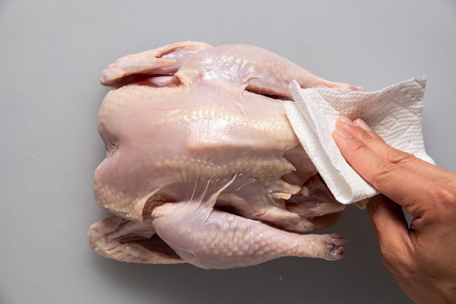 Paper towel use to remove excess moisture from whole chicken for chicken roast recipe 